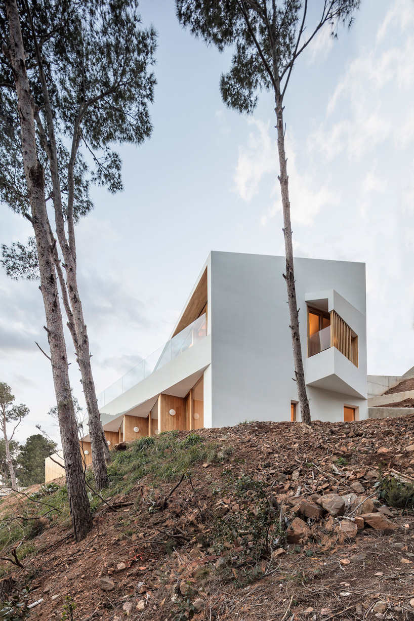 05 AM arquitectura's mediterranean house cascades down a steep slope in tamariu, spain