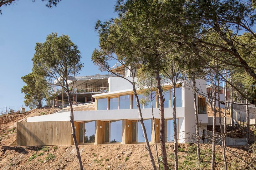 05 AM arquitectura's mediterranean house cascades down a steep slope in tamariu, spain