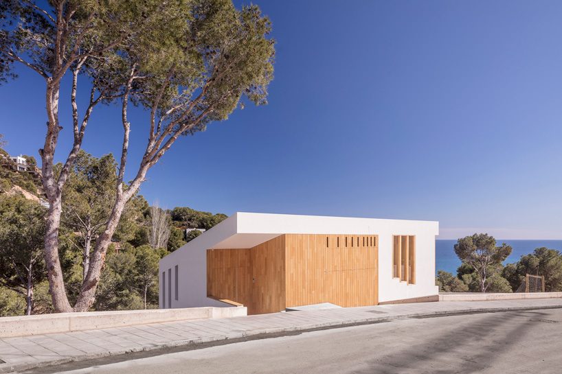 05 AM arquitectura's mediterranean house cascades down a steep slope in tamariu, spain