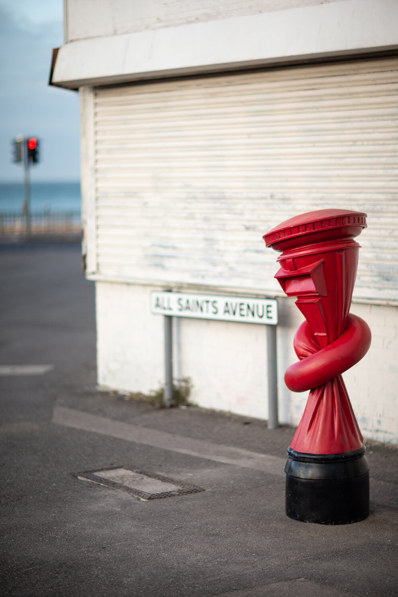 alex chinneck installs 'knotted' post boxes across the UK