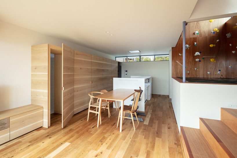 horibe associates installs climbing wall inside family house in tsukawaki, japan