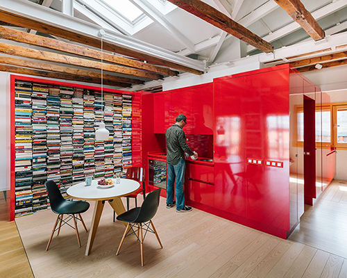 gon architects inserts a bright red, continuous furniture to articulate attic in madrid