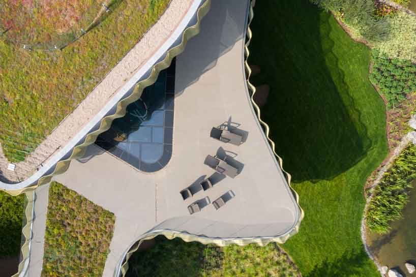 green roofs melt j.mayer.h's n.n. residence into the rolling hills of rural moscow designboom