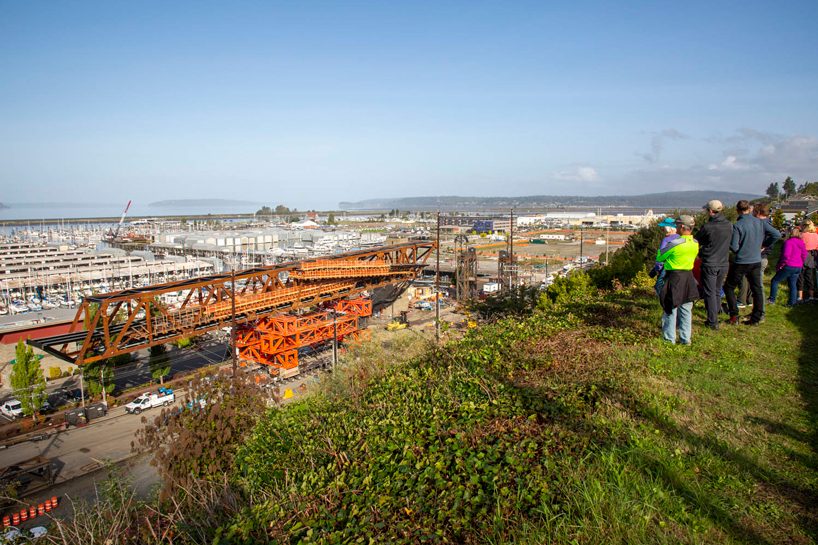 LMN architects utilizes weathered steel trusses to build pedestrian bridge in washington designboom