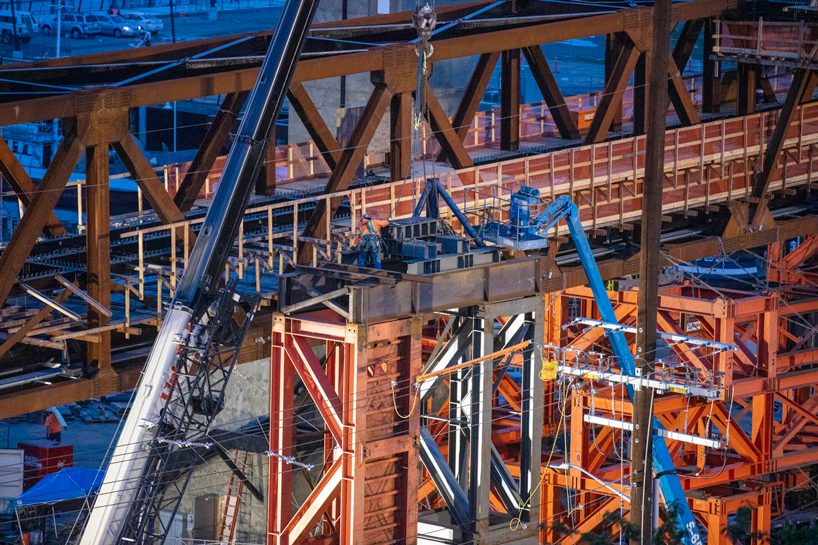 LMN architects utilizes weathered steel trusses to build pedestrian bridge in washington designboom