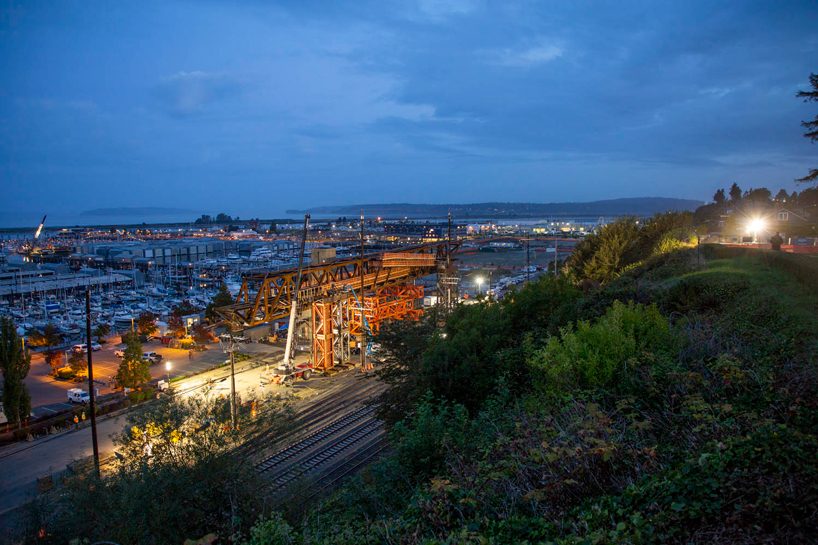 LMN architects utilizes weathered steel trusses to build pedestrian bridge in washington designboom