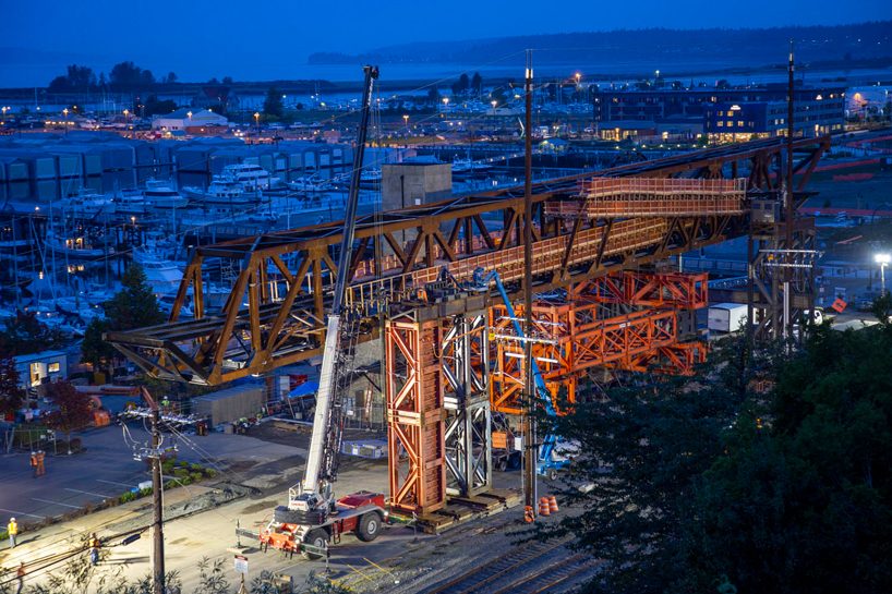 LMN architects utilizes weathered steel trusses to build pedestrian bridge in washington designboom