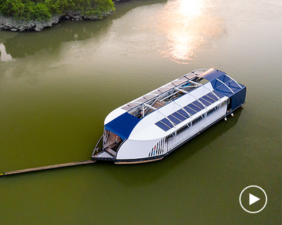the ocean cleanup unveils floating garbage truck that catches plastic in rivers