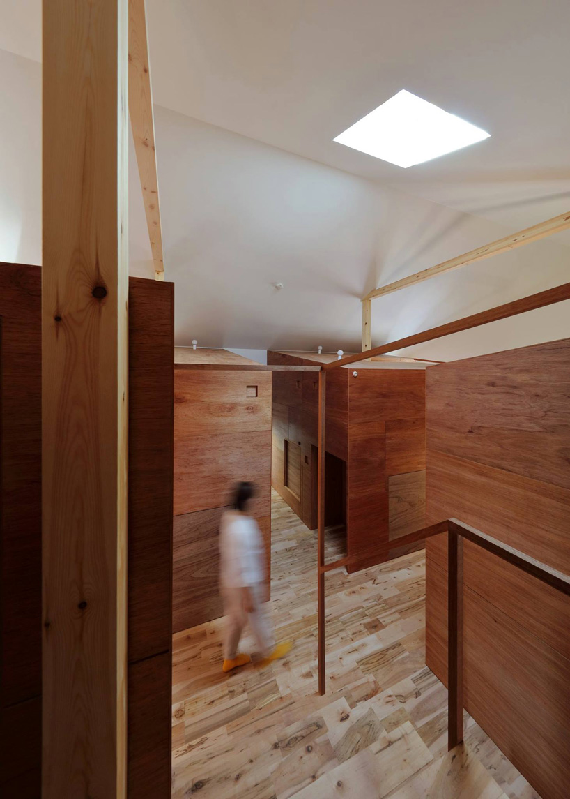  alphaville designs capsule hostel 'sui' in kyoto as cluster of wooden volumes