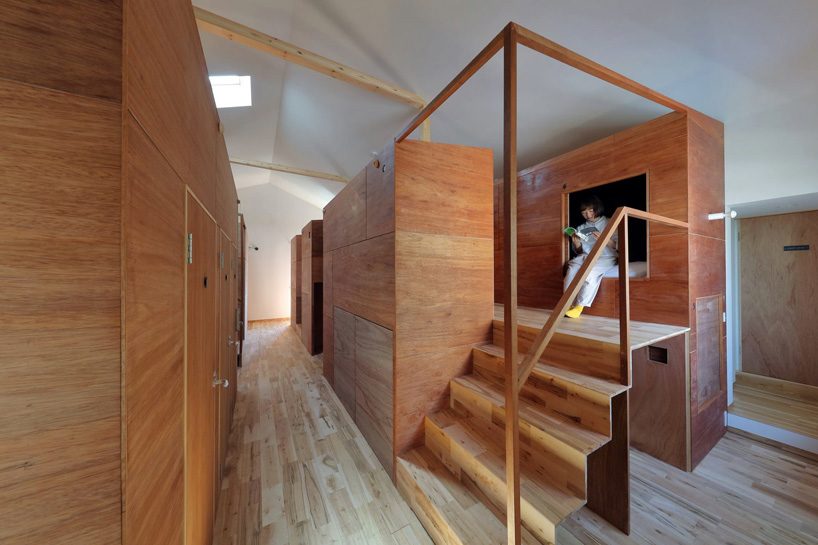  alphaville designs capsule hostel 'sui' in kyoto as cluster of wooden volumes