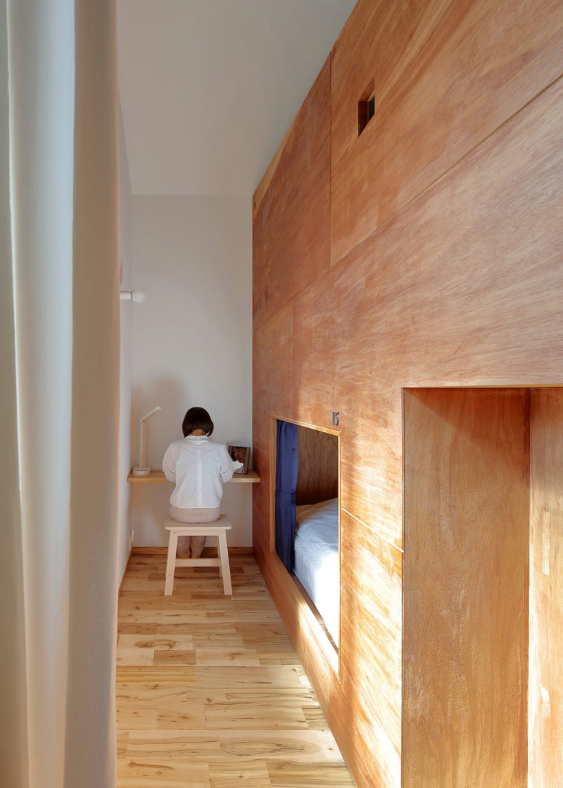  alphaville designs capsule hostel 'sui' in kyoto as cluster of wooden volumes