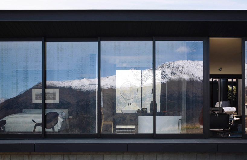 fearon hay architects builds house in new zealand's alps as cluster of blackened volumes