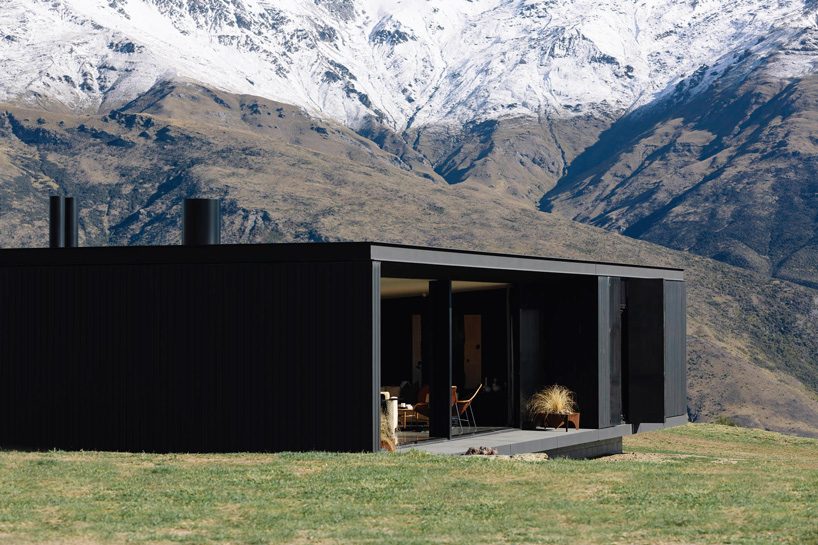 fearon hay architects builds house in new zealand's alps as cluster of blackened volumes