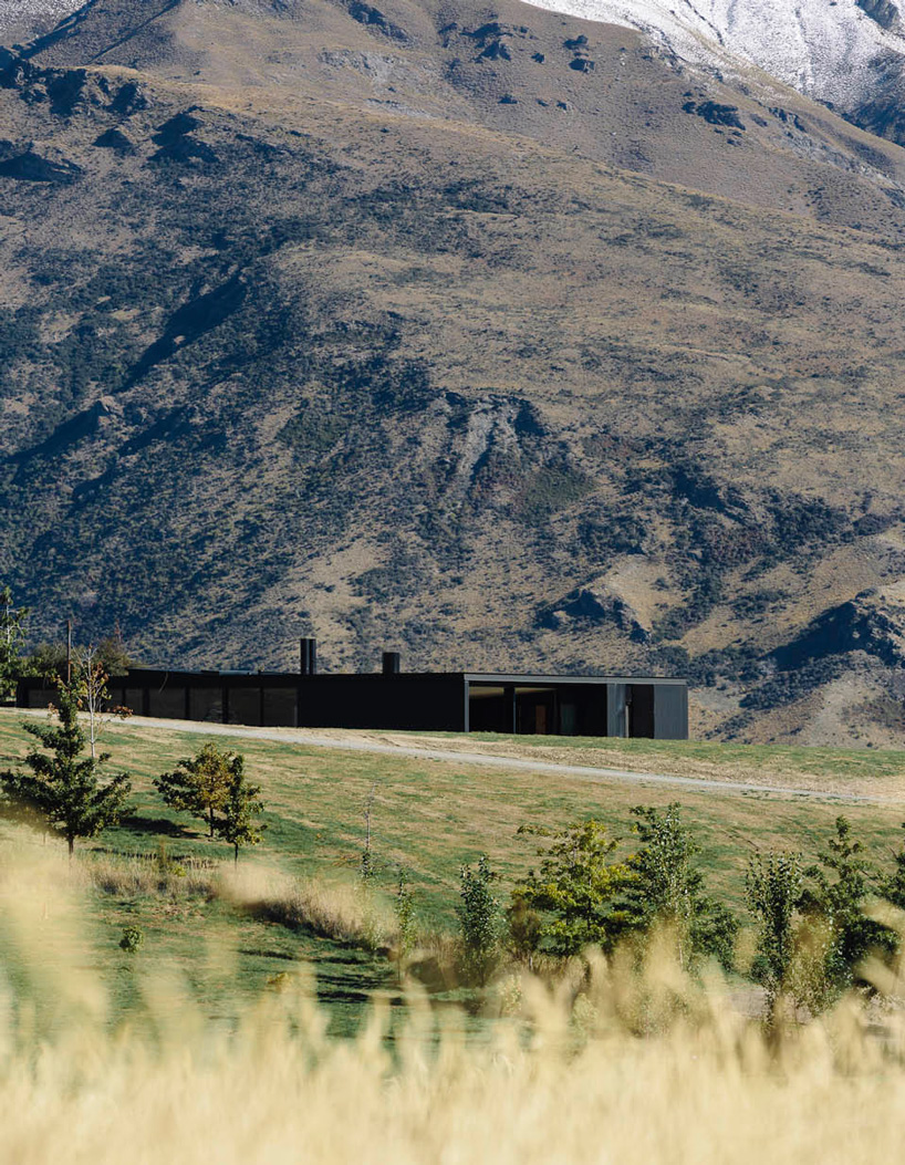 fearon hay architects builds house in new zealand's alps as cluster of blackened volumes