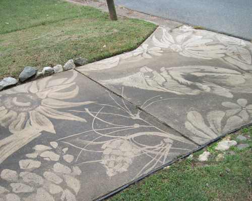 dianna wood uses power washer to create art on her dirty driveway