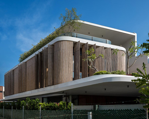 wallflower wraps house in singapore in a bamboo veil of operable screens