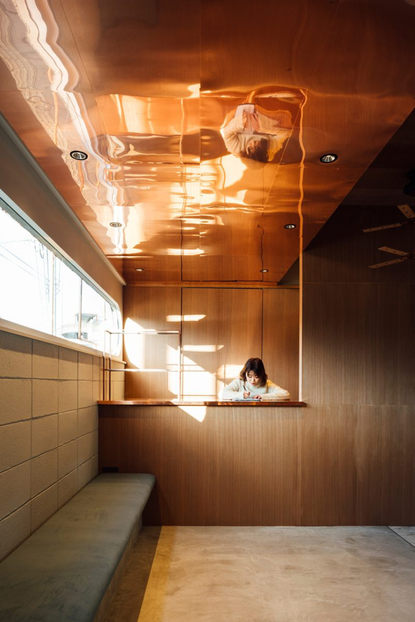 fathom finishes miyanishi yakeyama hair salon in japan with wall of greenery + copper pipes
