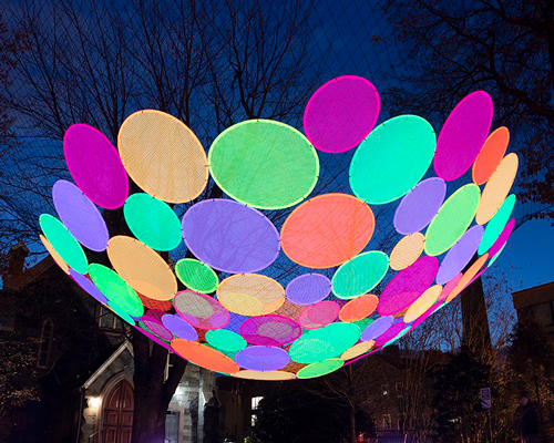 hou de sousa suspends the multi-colored 'atomic' installation in georgetown DC