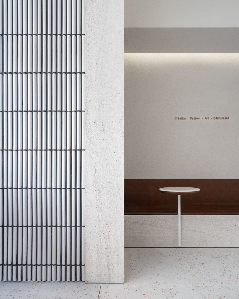 say architects clads angelot patisserie in hangzhou in a curved tile façade