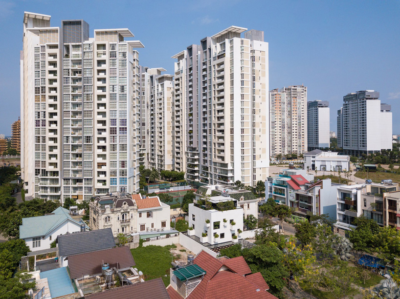 MIA design studio clads vietnamese house in façade of extruded planters and openings