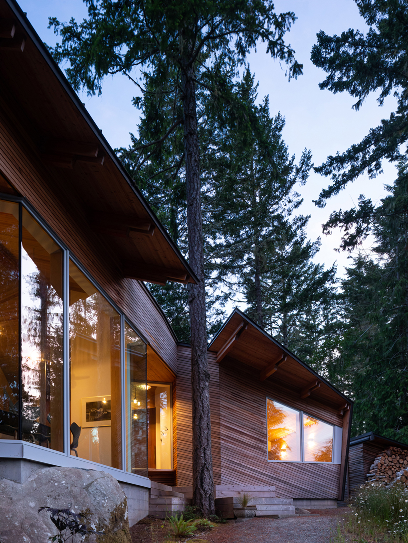 campos studio embeds the sooke house within the forest of a rocky hill in canada