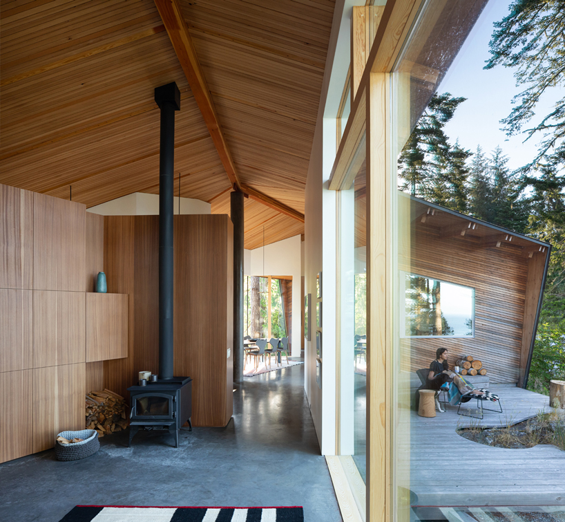campos studio embeds the sooke house within the forest of a rocky hill in canada