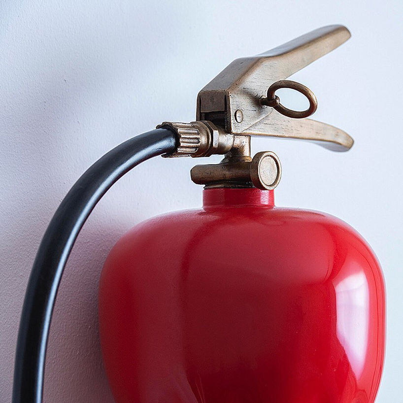 alex chinneck ties a knot in twisted fire extinguisher sculpture