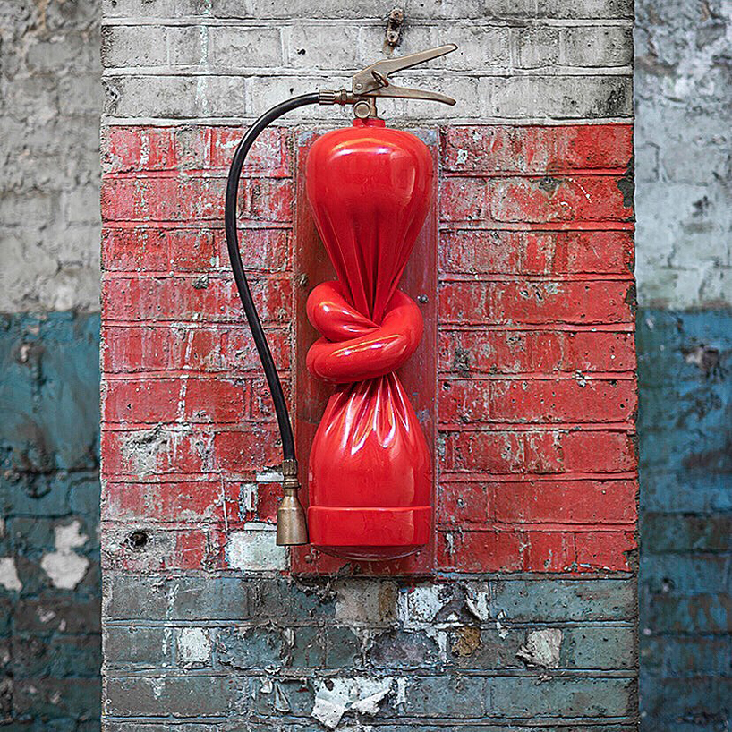 alex chinneck ties a knot in twisted fire extinguisher sculpture
