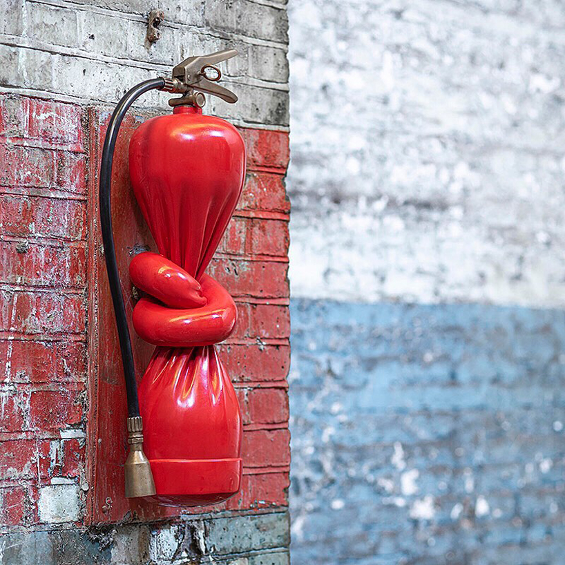 alex chinneck ties a knot in twisted fire extinguisher sculpture