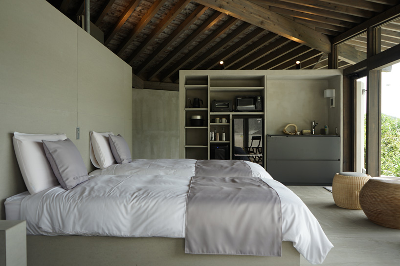 atelier tekuto + amami design firm build beachfront origami-like concrete villas in japan