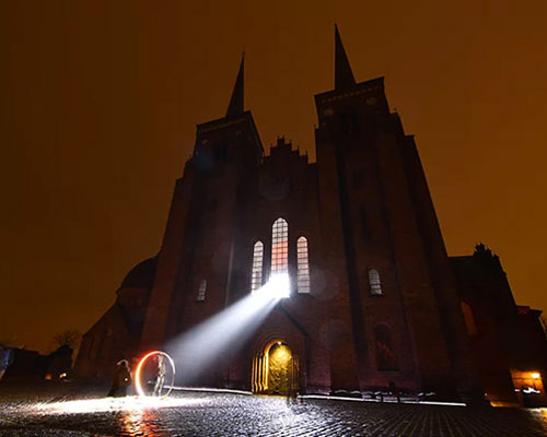 SIIKU's 'LUX NOVA' beams a circle of light outside roskilde cathedral in denmark