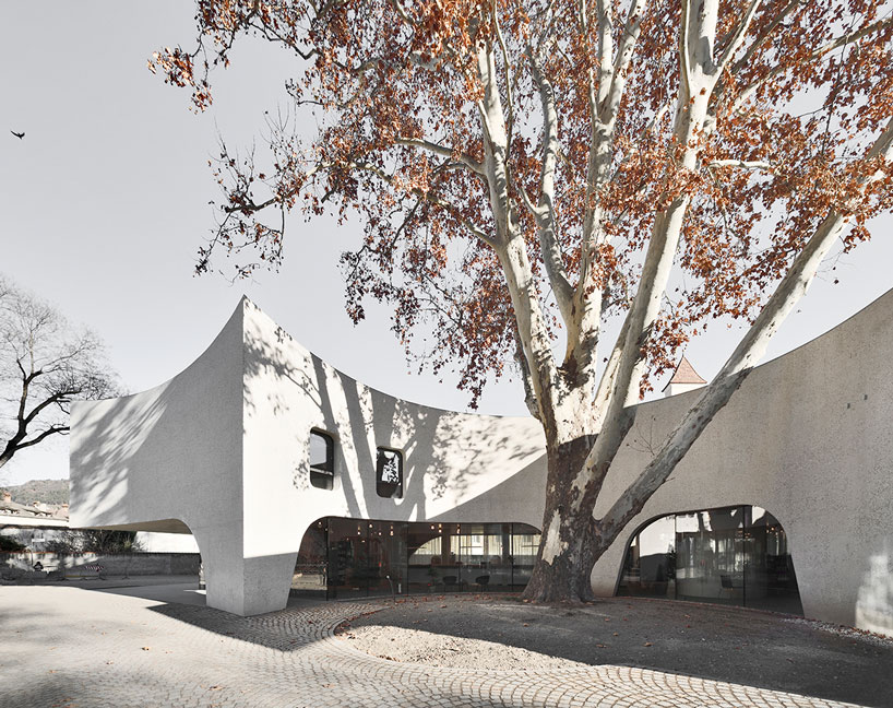 curving concrete wraps modus architects' 'treehugger' tourist office in italy designboom