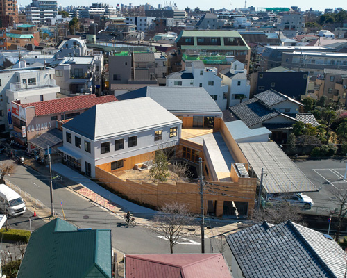 naf architect & design encloses 'small pond' nursery school in tokyo with curved wood façade
