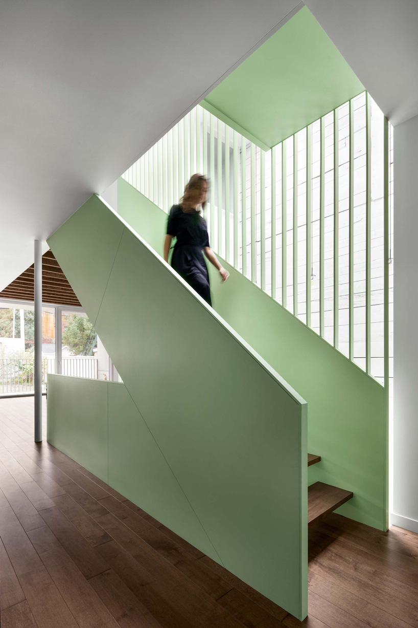 sage green staircase takes center stage in montreal residence renovation by naturehumaine