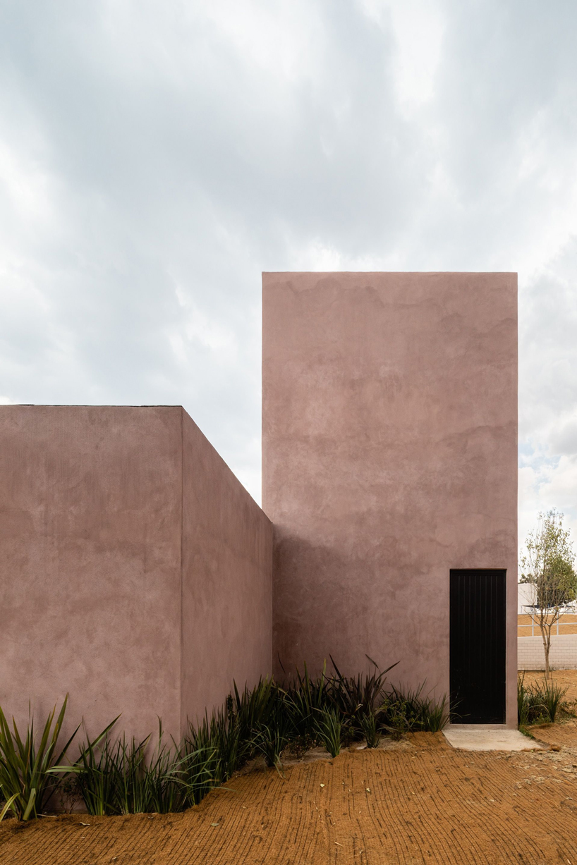 two pink adobe volumes form PPAA's prototype for social housing project in mexico designboom