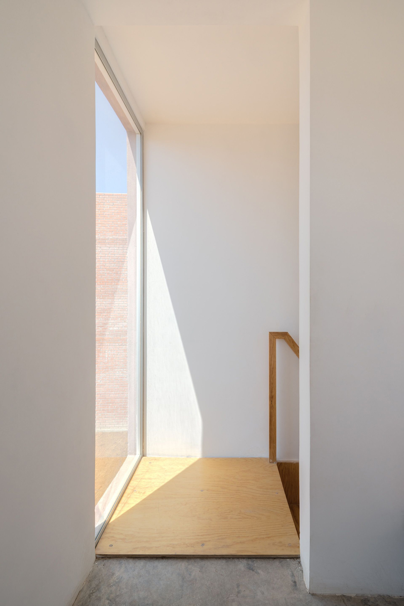 two pink adobe volumes form PPAA's prototype for social housing project in mexico designboom