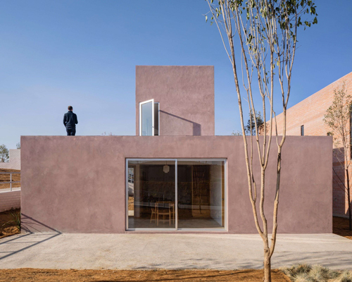 two pink adobe volumes form PPAA's prototype for a social housing project in mexico