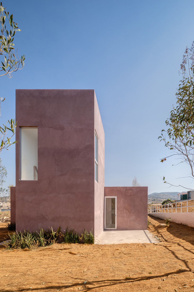 two pink adobe volumes form PPAA's prototype for social housing project in mexico designboom