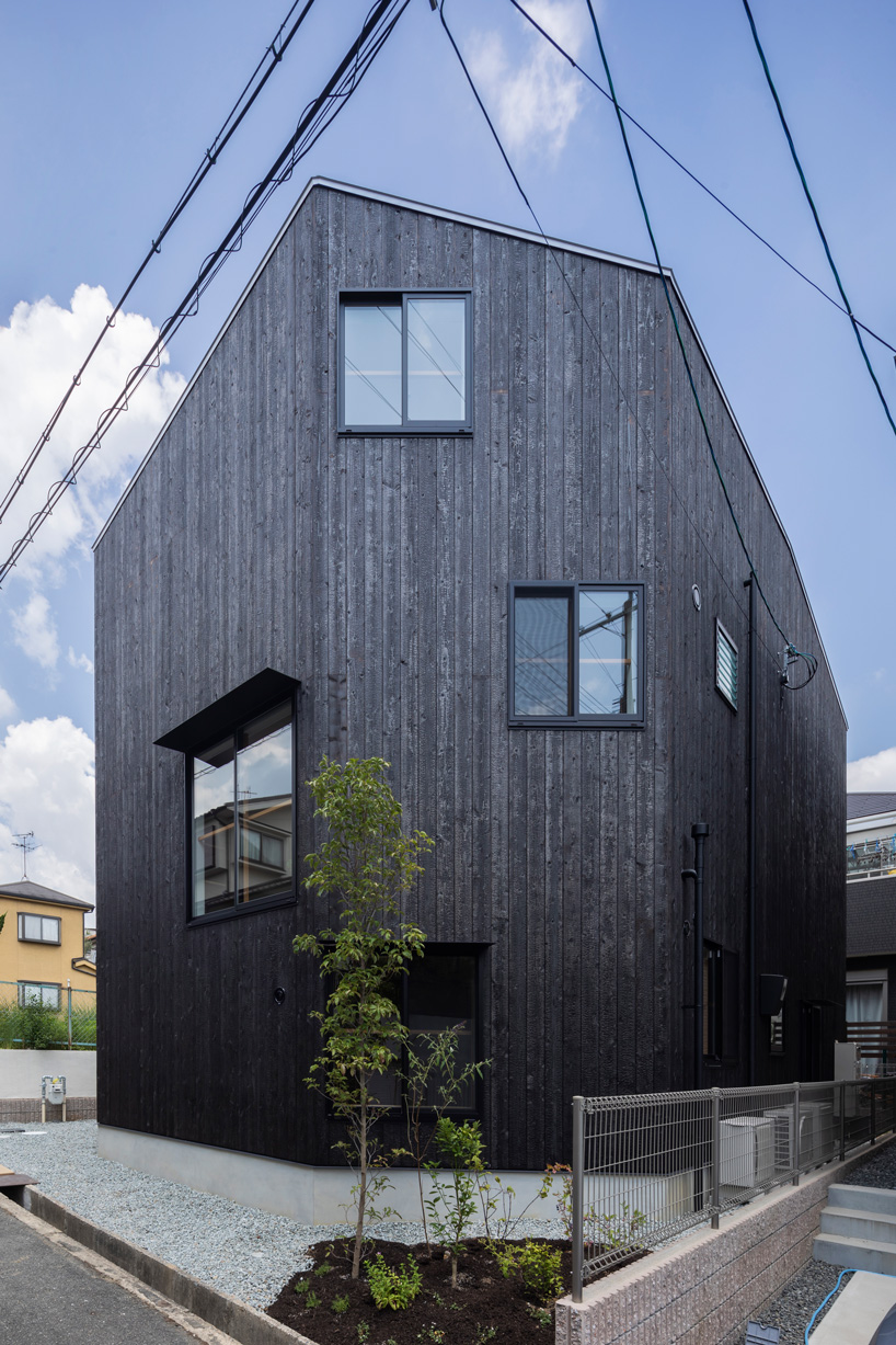 tato architects wraps house in takatsuki, japan, in charred wood exterior