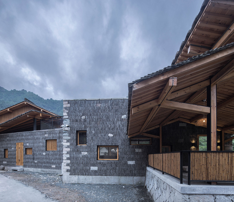 shulin architectural design sets stone + wood hotel within an ancient village in china