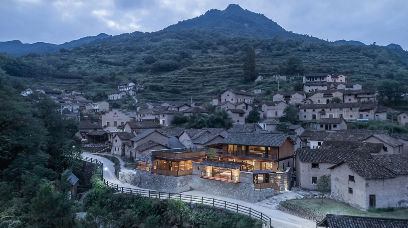 shulin architectural design sets stone + wood hotel within an ancient village in china