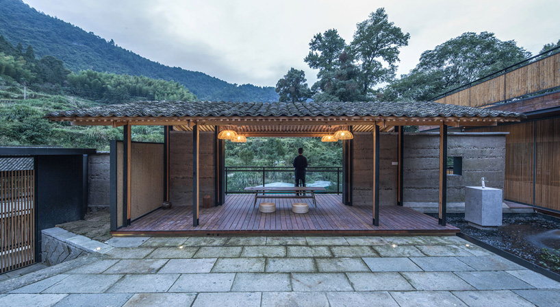 shulin architectural design sets stone + wood hotel within an ancient village in china