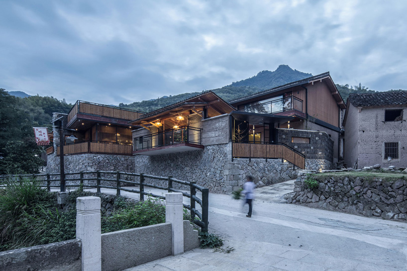 shulin architectural design sets stone + wood hotel within an ancient village in china