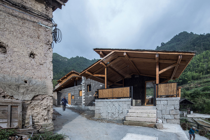 shulin architectural design sets stone + wood hotel within an ancient village in china