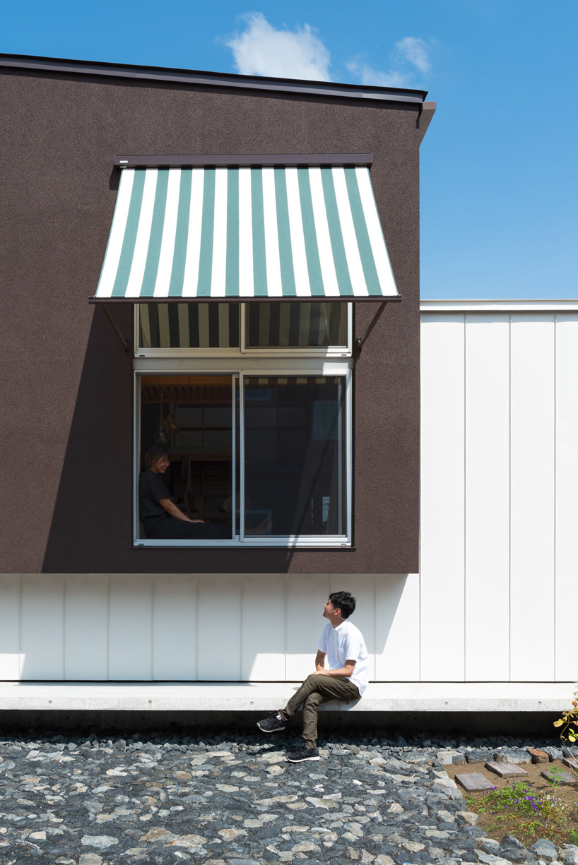 two contrasting volumes intersect in takeru shoji architects' house in kitanyuugura, japan