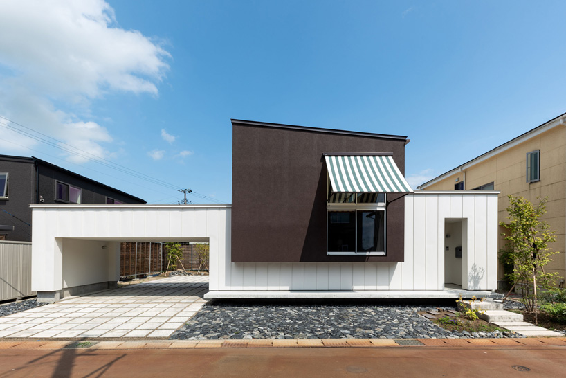 two contrasting volumes intersect in takeru shoji architects' house in kitanyuugura in japan