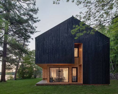 charred timber and receding volumes define atelier schwimmer's lakeside chalet in quebec