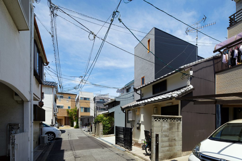 fujiwaramuro architects' narrow house in tezukayama, japan, is built around a 'shelf-staircase'