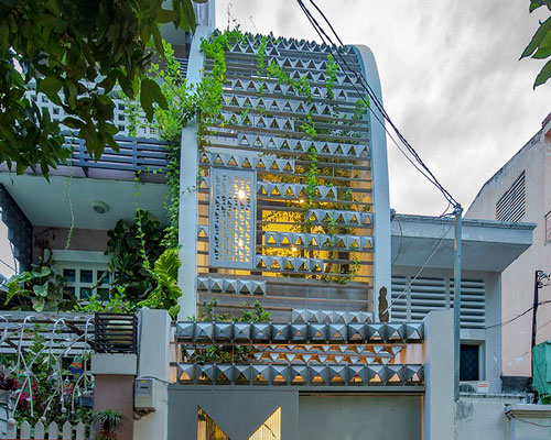 KHUÔN studio shields an inner oasis with 'armored' façade in ho chi minh city