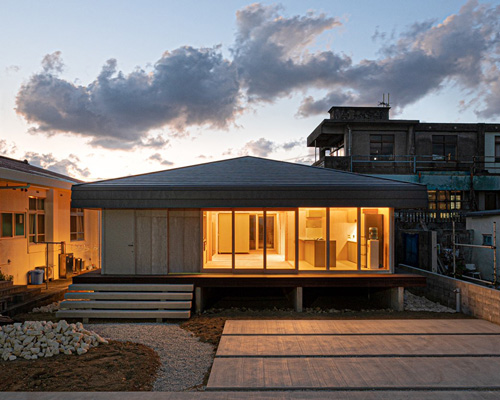 studio monaka lifts wooden house on set of concrete foundations in japan
